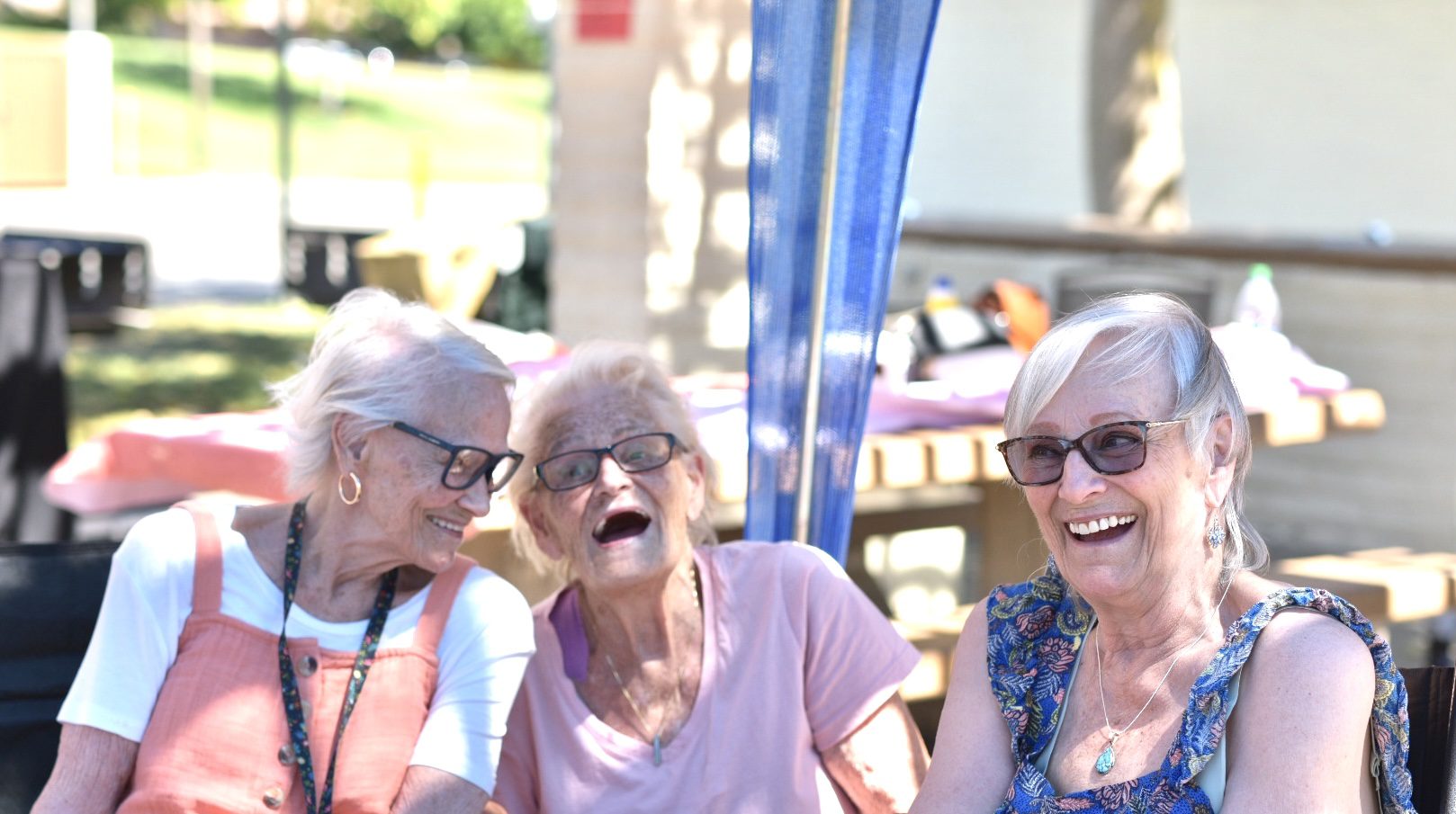 Three older women sitting next to each other.