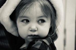 A little girl with a hat on her head.