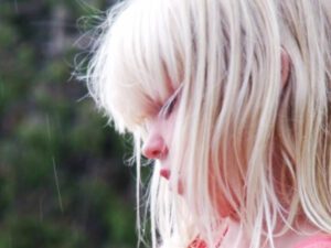 A close up of a person with blonde hair