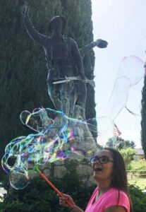 A woman is blowing bubbles in the air.