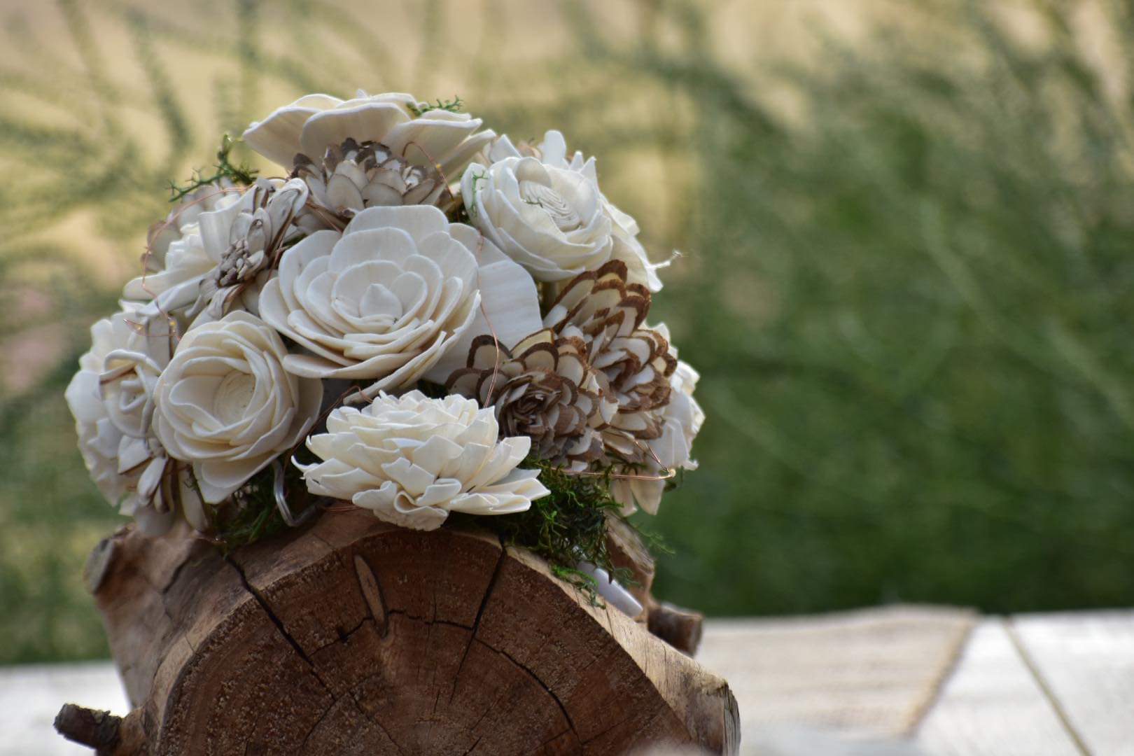 A bouquet of flowers sitting on top of a wooden table.