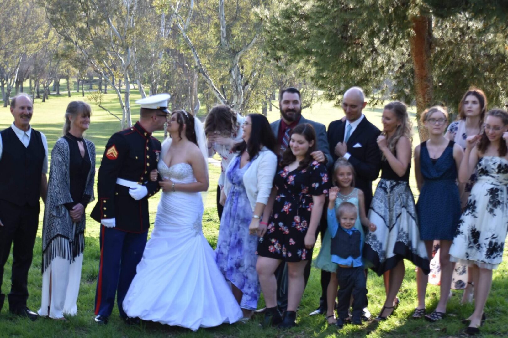 A group of people standing in the grass.