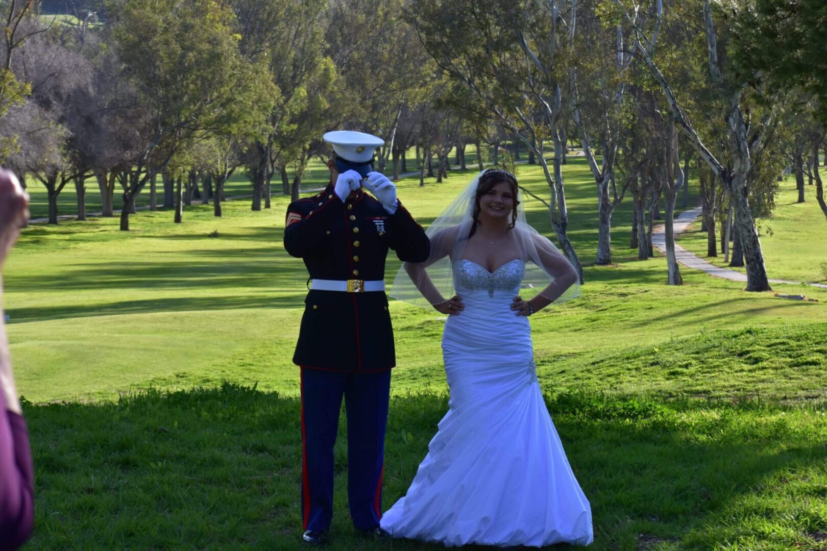 A man in uniform and woman in wedding dress.