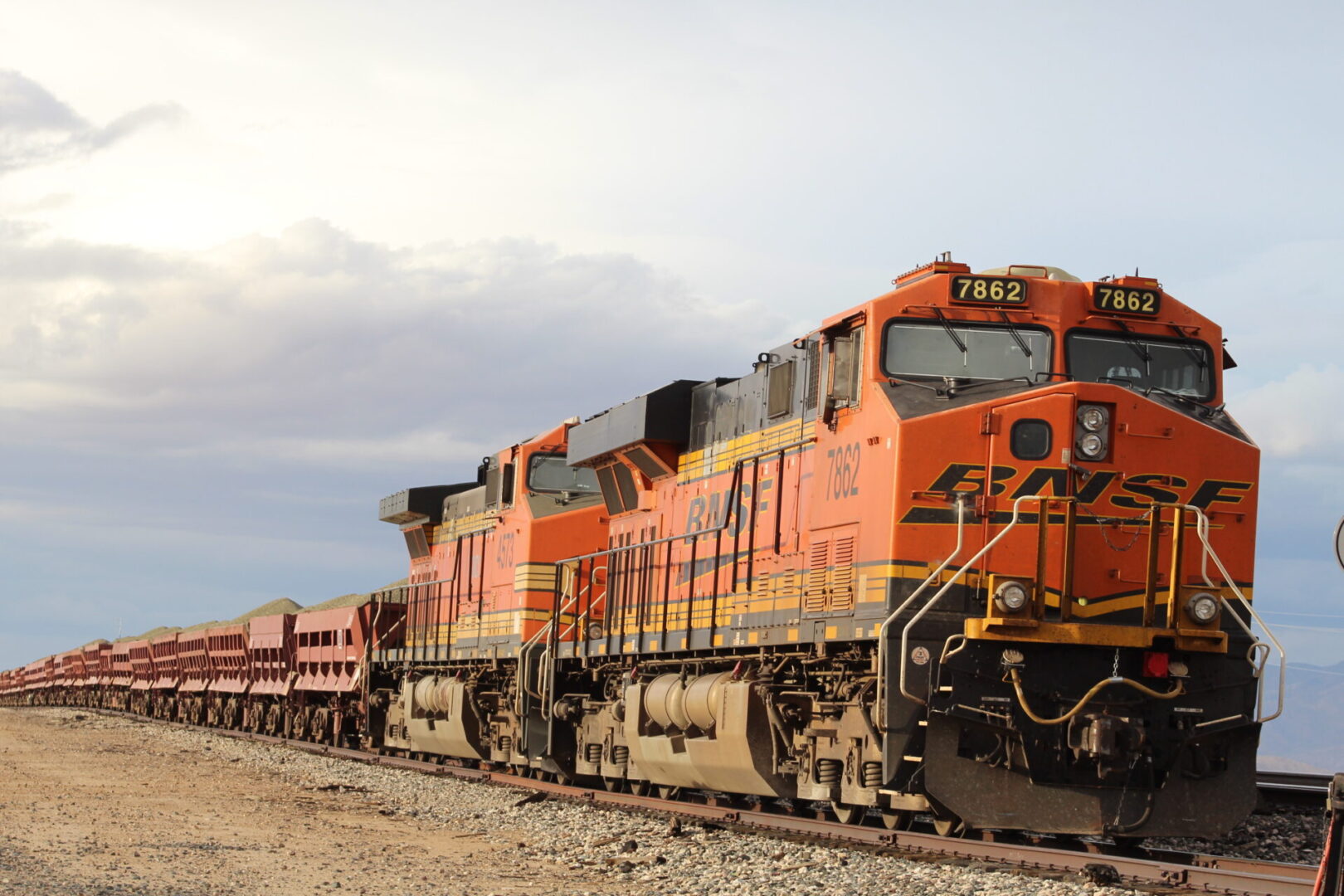 A train is on the tracks near some trees.