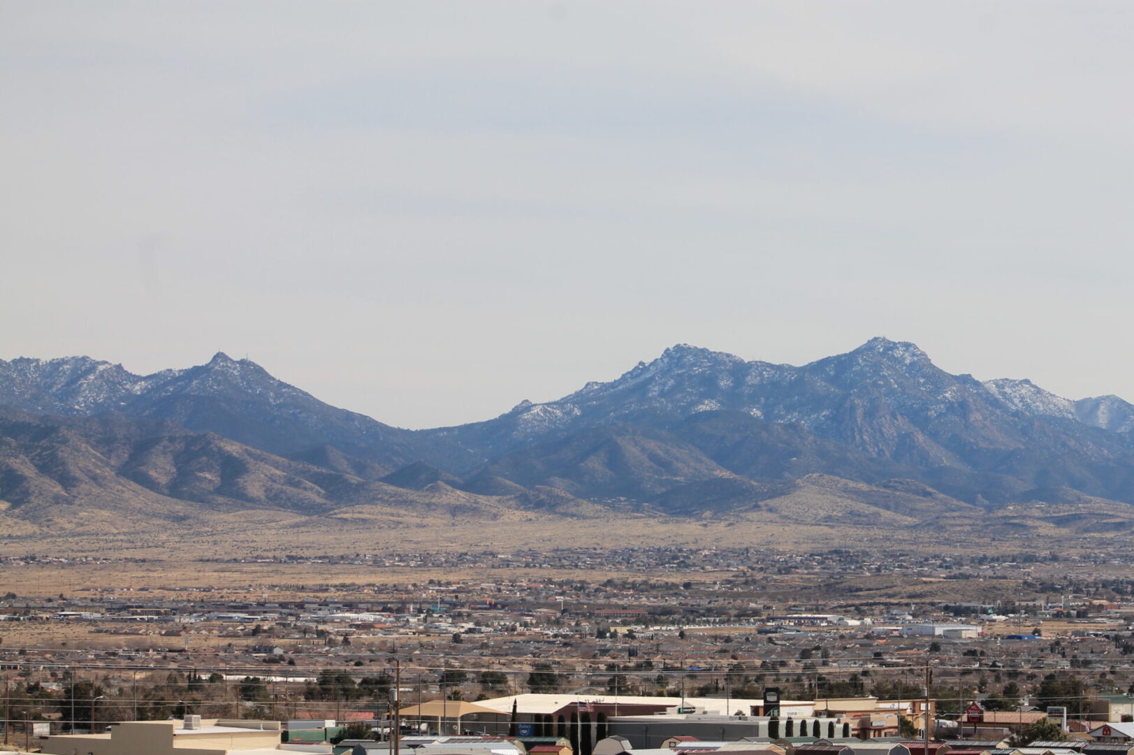 A view of mountains and the city from afar.