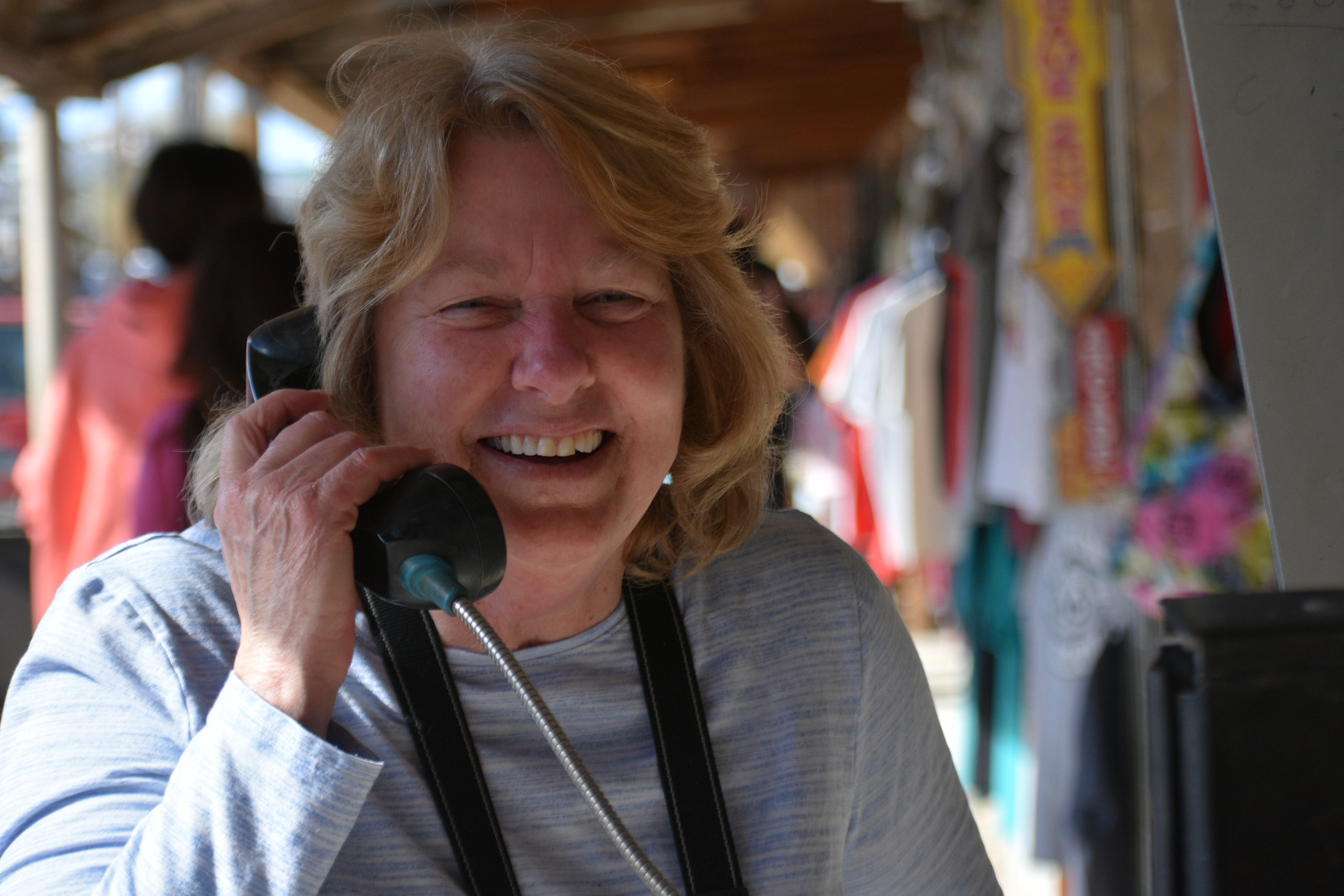 A woman talking on the phone while wearing a neck brace.