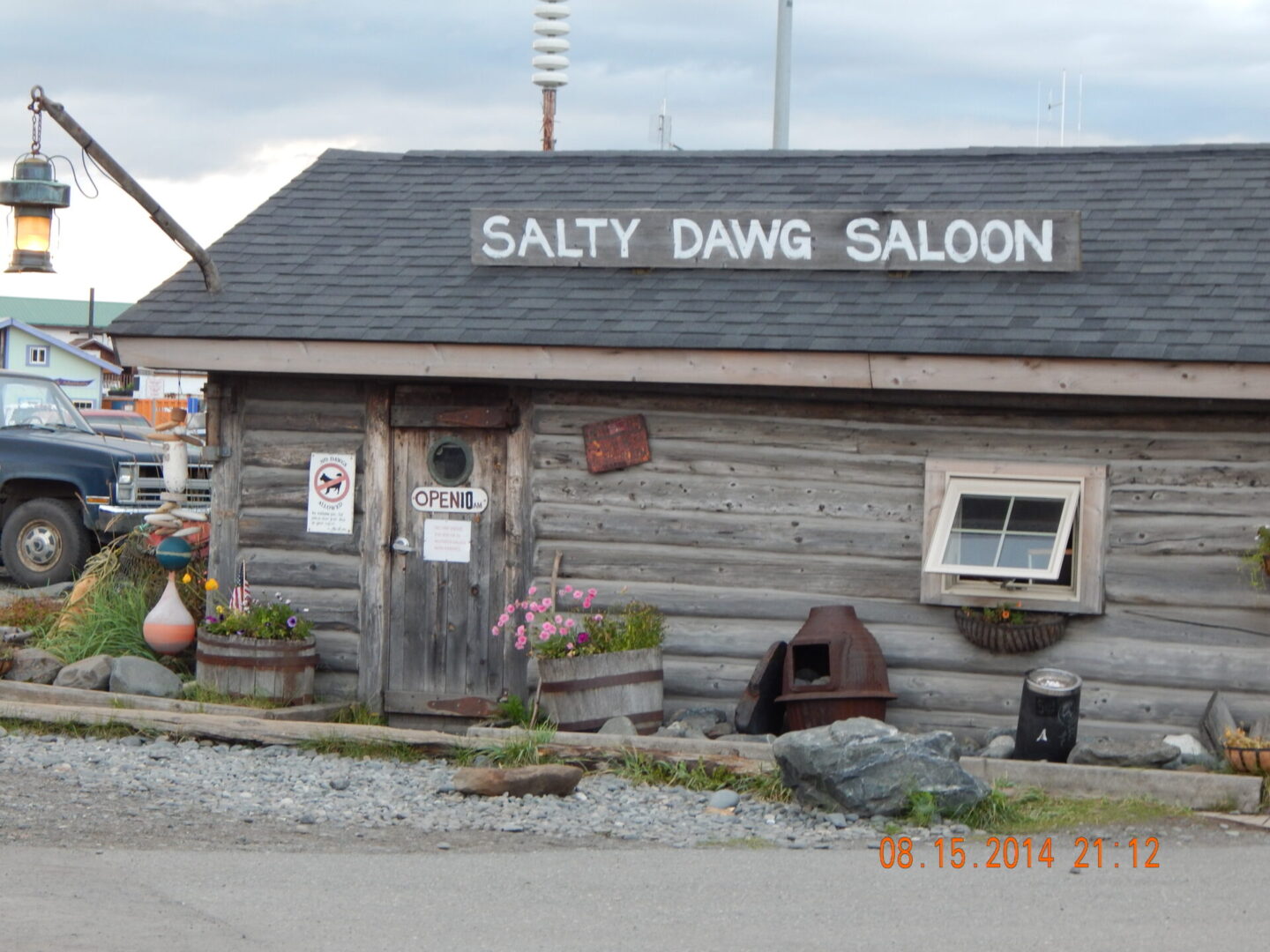 A wooden building with a sign on the front of it.