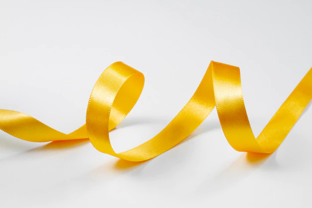 A yellow ribbon is curled up on top of the table.