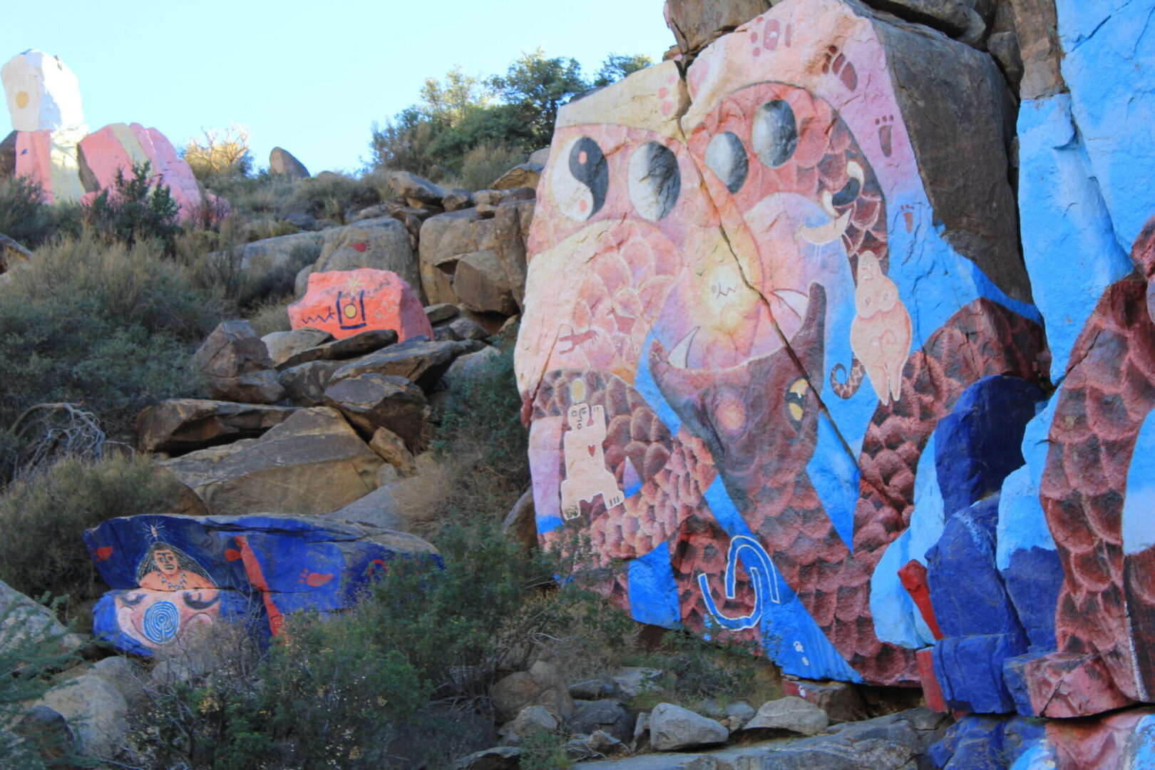 A rock with many different colors and designs on it.