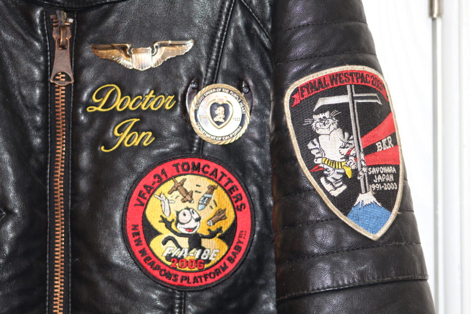 A close up of some patches on the jacket