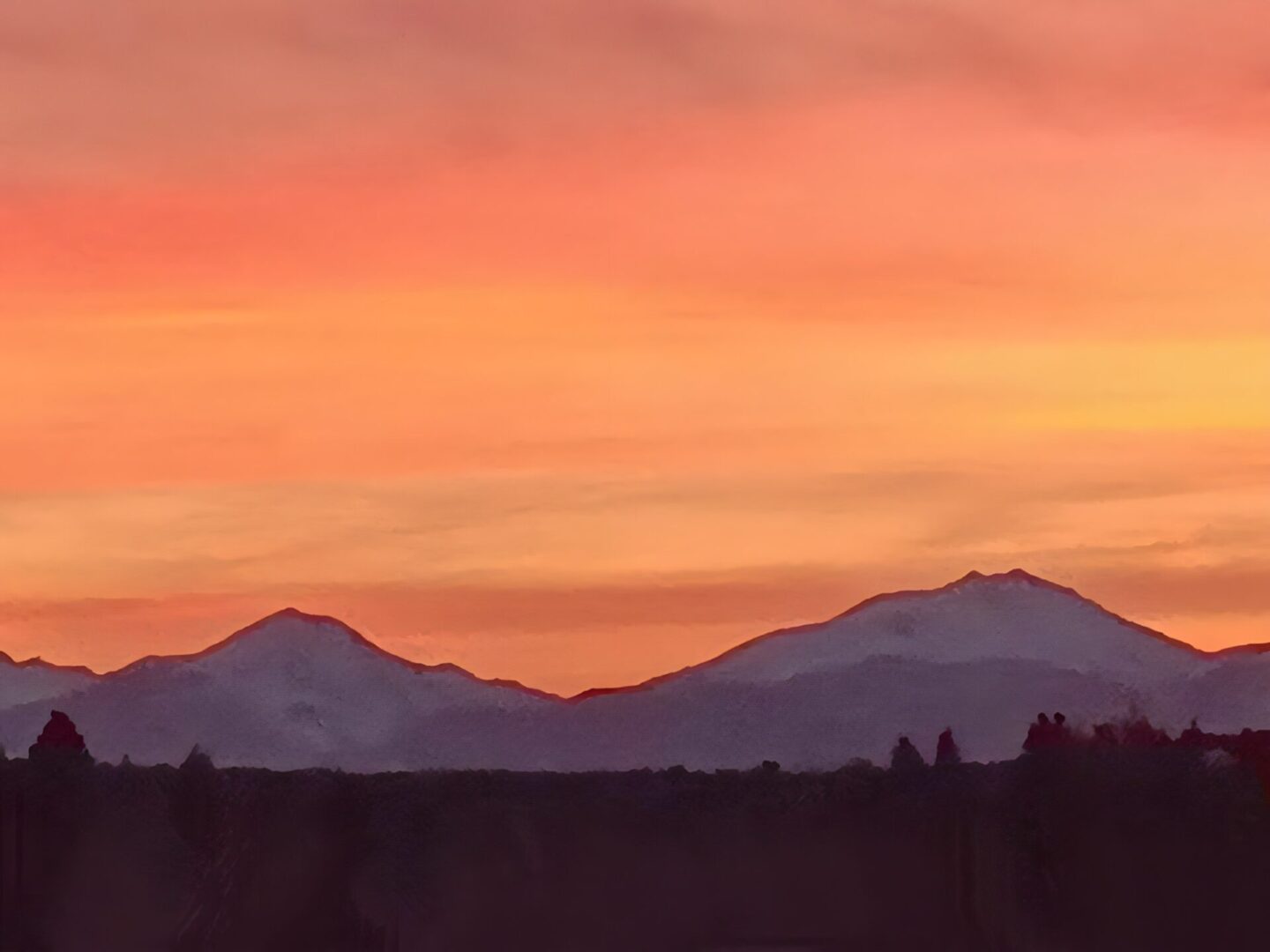 A sunset with mountains in the background.