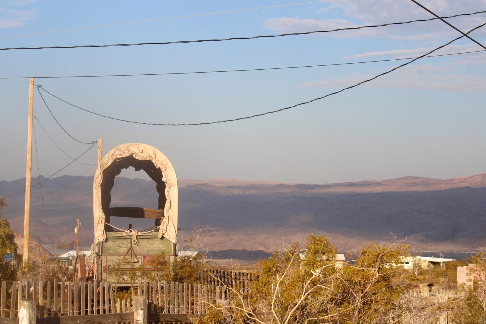 A view of a desert landscape with power lines.