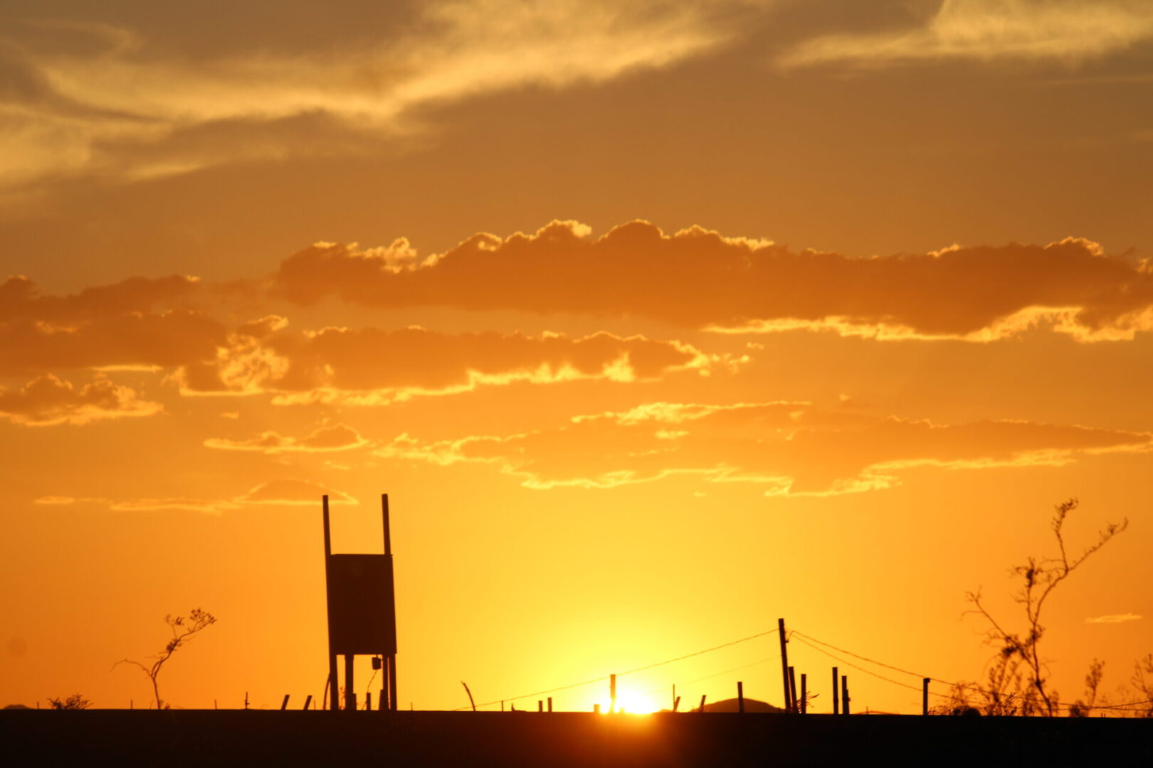 A sunset with the sun setting in the background.