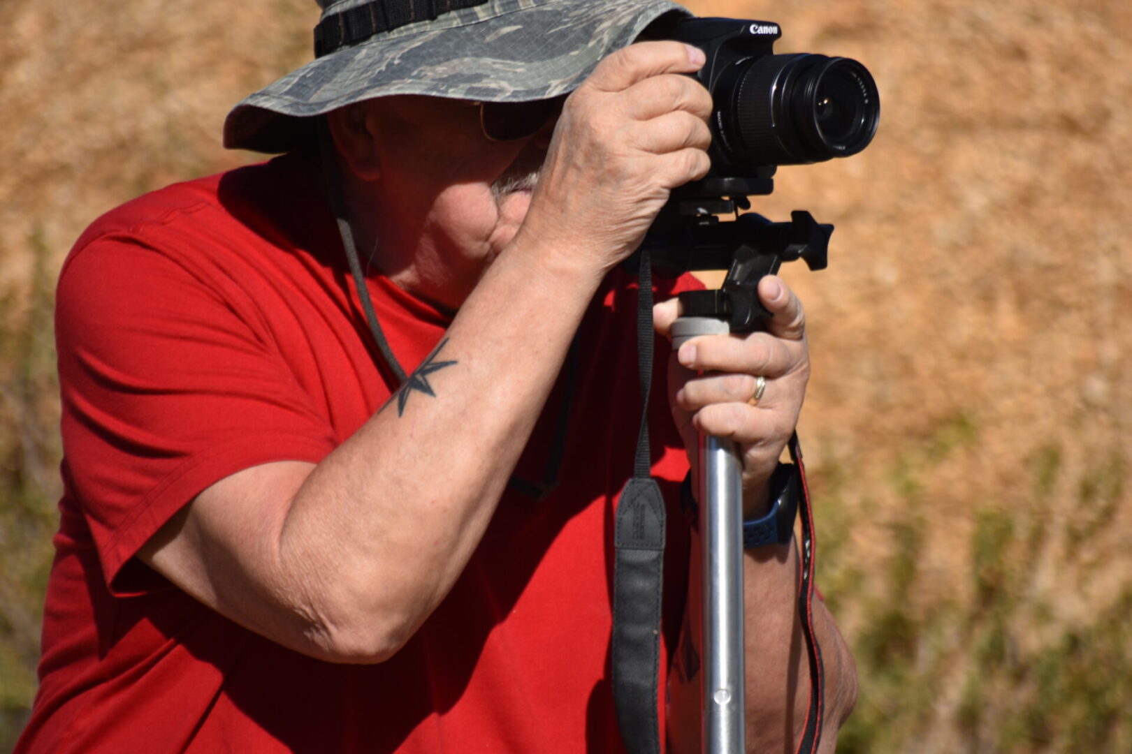 A person taking pictures with a camera on a tripod.